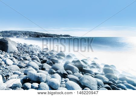 Background of water and rolling stones at Moelen