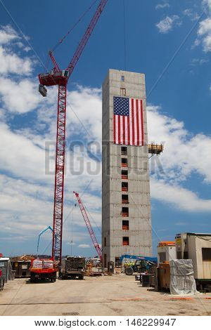 BOSTON,MASSACHUSETTS,USA - JULY 15,2016: New construction luxury condos on Fan Pier in Boston. Huge American flag adorns buildings under construction along Harborwalk in South Boston