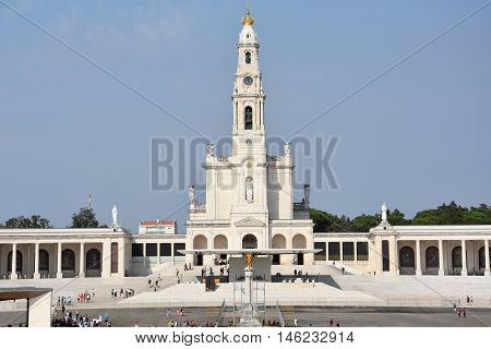 FATIMA, PORTUGAL - AUG 24: Sanctuary of Fatima in Portugal, as seen on Aug 24, 2016. It consists of a tall centralized bell-tower and nave, 213 ft in height, decorated by a 15,000 lb crown of bronze.