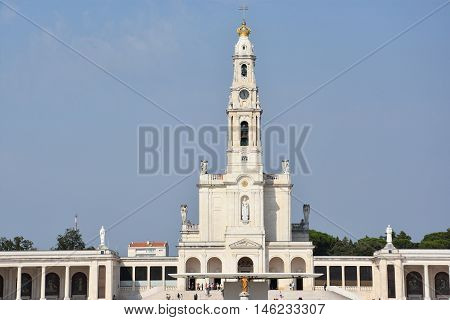 FATIMA, PORTUGAL - AUG 24: Sanctuary of Fatima in Portugal, as seen on Aug 24, 2016. It consists of a tall centralized bell-tower and nave, 213 ft in height, decorated by a 15,000 lb crown of bronze.