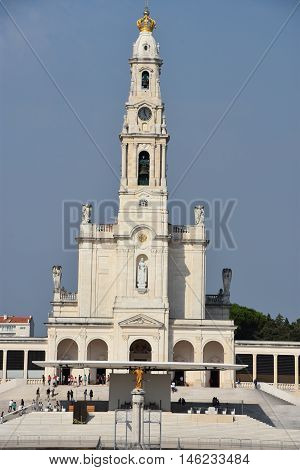 FATIMA, PORTUGAL - AUG 24: Sanctuary of Fatima in Portugal, as seen on Aug 24, 2016. It consists of a tall centralized bell-tower and nave, 213 ft in height, decorated by a 15,000 lb crown of bronze.