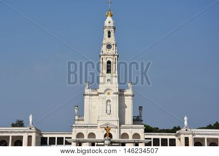 FATIMA, PORTUGAL - AUG 24: Sanctuary of Fatima in Portugal, as seen on Aug 24, 2016. It consists of a tall centralized bell-tower and nave, 213 ft in height, decorated by a 15,000 lb crown of bronze.