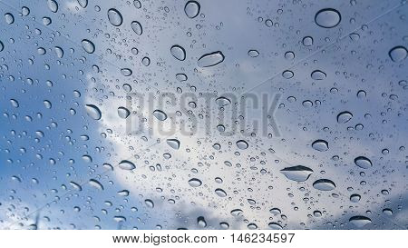 Rain drops on the window. with blue sky