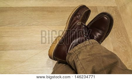 Feet. First-Person view on wood Floor background.