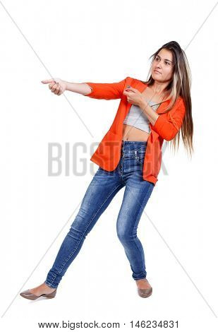 back view of standing girl pulling a rope from the top or cling to something. girl watching. girl in a red jacket, pulls the rope side.