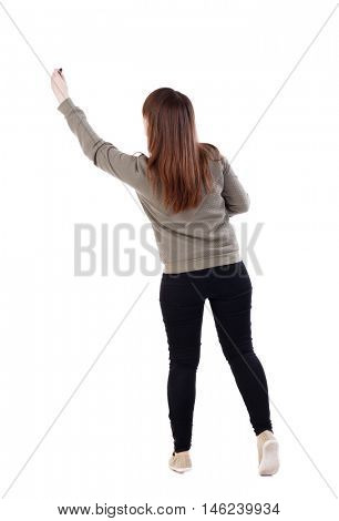 back view of writing beautiful woman. Isolated over white background. A young girl in a gray sweater pulled up with a felt-tip pen in a hand.