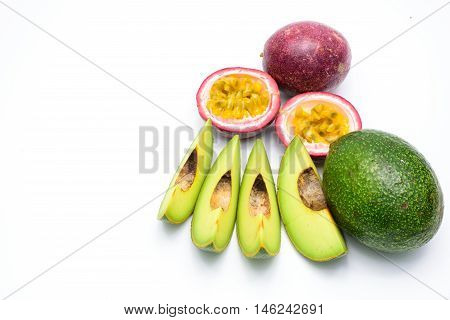 Group of avocados and passion fruit isolated on a white background