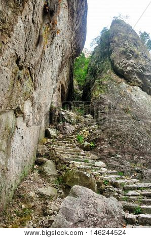 A stone stairwell leading up near a cliff in the Fangdong Scenic Area on Yandangshan mountains located in Zhejiang province China.