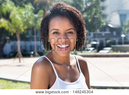 Happy latin american woman outdoor in the summer in the city