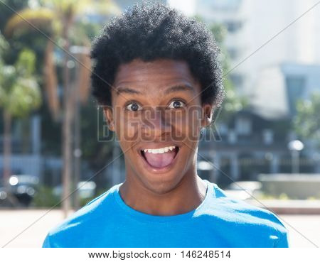 Surprised latin american guy outdoor in the summer in the city