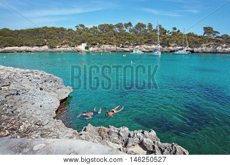 Couple Snorkeling In Clear Turquoise Water