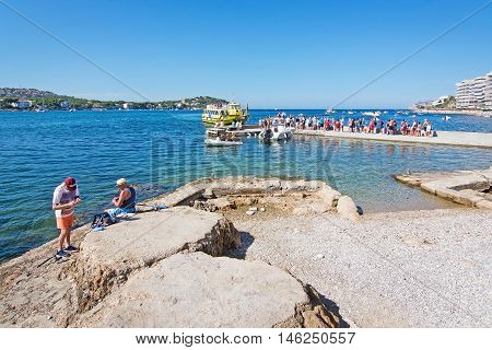 People Fish And Stand In Line For A Boat Ride