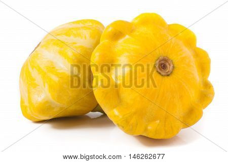 two yellow pattypan squash isolated on white background.