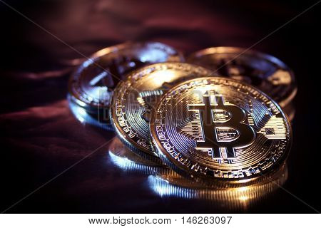 Photo Golden Bitcoins new virtual money Close-up on a black background.