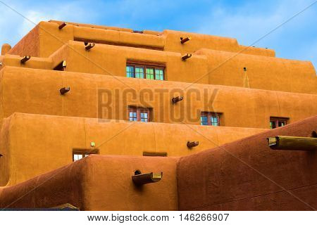 Southwestern adobe style building with a mixture of modern and historical architectural design taken in Santa Fe, NM