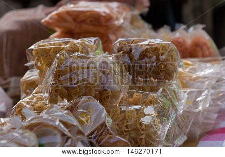 Various thai snack in plastick bag on local market in temple festival.