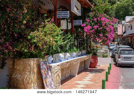 SPILI, CRETE, GREECE - JULY 2016: Street of Spili town with souvenir shops and taverns on Crete island.