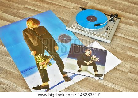 VILNIUS, LITHUANIA - 2015: Christine and the Queens vinyl record Chaleur humaine album, record player with a vinyl on a wooden floor.