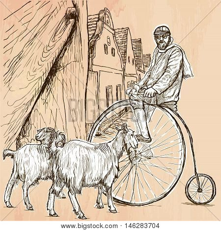BICYCLIST. Cyclist on the velocipede posing at the old village. In front of old houses are also two goats. Freehand sketching line drawing. An hand drawn vector illustration. Line art technique.