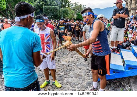 Antigua Guatemala - September 14 2015: Runners light torches while blowing whistles outside city hall during Guatemalan Independence Day celebrations