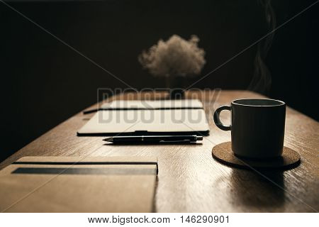 Coffee table with cup of coffee smoking in coffee shop. Relaxing in coffee shop.