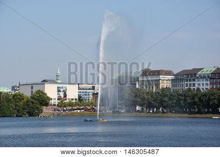 HAMBURG, GERMANY - AUG 26: Fountain at Alster Lake in Hamburg, Germany, as seen on Aug 26, 2016. In the city center, the Alster river forms two lakes, both prominent features in Hamburg's cityscape.