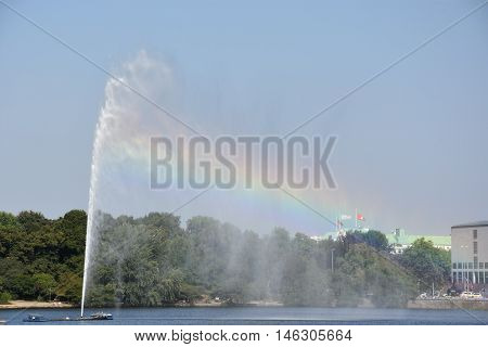HAMBURG, GERMANY - AUG 26: Fountain at Alster Lake in Hamburg, Germany, as seen on Aug 26, 2016. In the city center, the Alster river forms two lakes, both prominent features in Hamburg's cityscape.