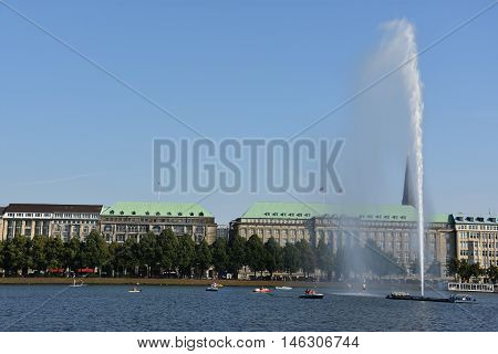 HAMBURG, GERMANY - AUG 26: Fountain at Alster Lake in Hamburg, Germany, as seen on Aug 26, 2016. In the city center, the Alster river forms two lakes, both prominent features in Hamburg's cityscape.