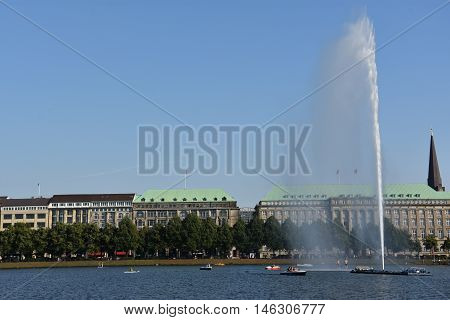 HAMBURG, GERMANY - AUG 26: Fountain at Alster Lake in Hamburg, Germany, as seen on Aug 26, 2016. In the city center, the Alster river forms two lakes, both prominent features in Hamburg's cityscape.