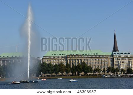 HAMBURG, GERMANY - AUG 26: Fountain at Alster Lake in Hamburg, Germany, as seen on Aug 26, 2016. In the city center, the Alster river forms two lakes, both prominent features in Hamburg's cityscape.