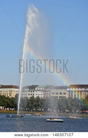 HAMBURG, GERMANY - AUG 26: Fountain at Alster Lake in Hamburg, Germany, as seen on Aug 26, 2016. In the city center, the Alster river forms two lakes, both prominent features in Hamburg's cityscape.