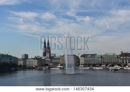 HAMBURG, GERMANY - AUG 26: Fountain at Alster Lake in Hamburg, Germany, as seen on Aug 26, 2016. In the city center, the Alster river forms two lakes, both prominent features in Hamburg's cityscape.