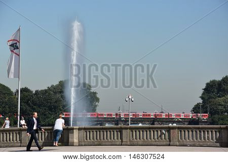 HAMBURG, GERMANY - AUG 26: Fountain at Alster Lake in Hamburg, Germany, as seen on Aug 26, 2016. In the city center, the Alster river forms two lakes, both prominent features in Hamburg's cityscape.