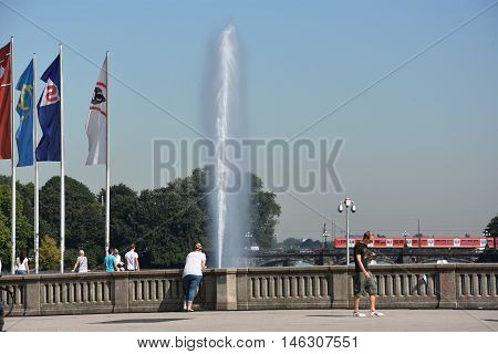 HAMBURG, GERMANY - AUG 26: Fountain at Alster Lake in Hamburg, Germany, as seen on Aug 26, 2016. In the city center, the Alster river forms two lakes, both prominent features in Hamburg's cityscape.
