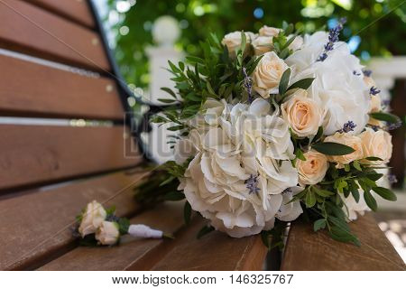 Beautiful Bridal Bouquet And Boutonniere On A Wooden Bench