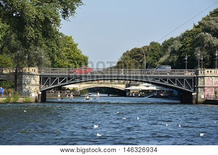 HAMBURG, GERMANY - AUG 26: Bridge on Lake Alster in Hamburg, Germany, as seen on Aug 26, 2016. Hamburg was founded at the mouth of Alster river in the 9th century and has been used as a port since.