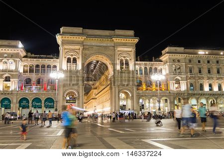 MILAN, ITALY - AUGUST 14, 2016: People walking in the Duomo Square by the gallery of Vittorio Emmanuil II during the night. 