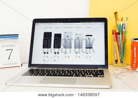 PARIS FRANCE - SEP 8 2016: Apple Computers website on MacBook Pro Retina in a geek creative room environment showcasing showcasing all iPhone models from iPhone SE to iPhone 7