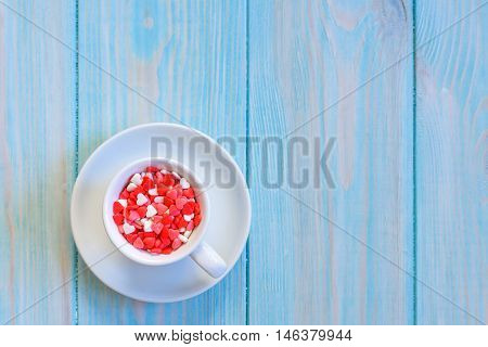 Coffee Cup Full Of Candies Flat Lay On Rustic Light Blue Wooden Background
