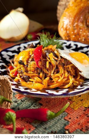 Asian Style Noodles with Meat and Laghman Sauce. Garnished with Fried Egg