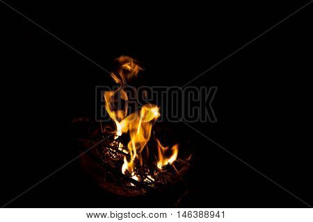 flame in a brazier on black background