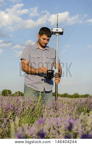 Geodesy measurement in a lavender field in countryside
