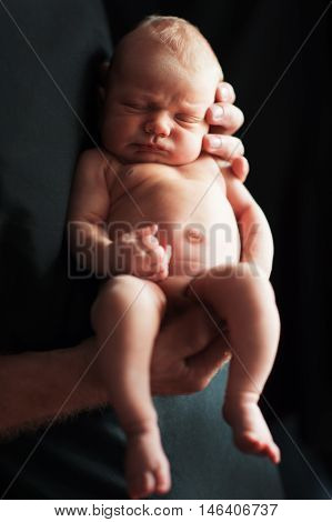 Father holding newborn baby. Portrait of a newborn boy.