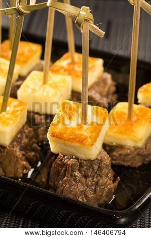 Gourmet skewer portion of meat with cheese curds