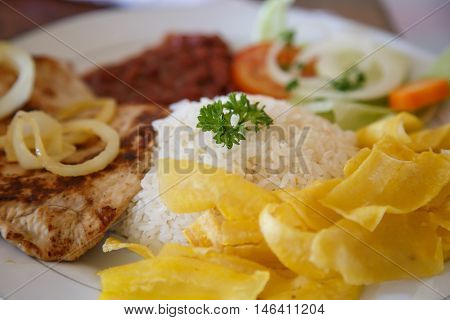 rice with chicken beans and salad from Nicaraguan cuisine