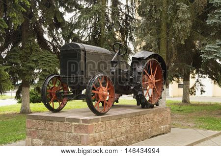 photo on the first Soviet tractor with metal wheels HTZ. Belarus