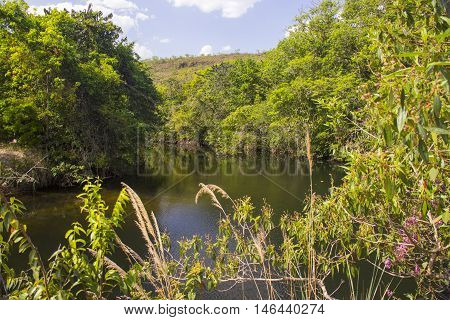 Beautiful Lake In Sunny Day Formed By Waterfalls