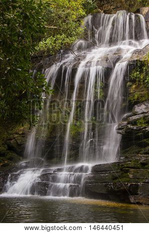 Beautiful waterfall between rocks in sunny day.