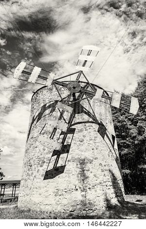 Old tower windmill in Holic Slovak republic. Architectural theme. Vertical composition. Cultural heritage. Black and white photo. Beautiful object. Travel destination.