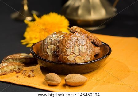 Typical Dutch filled spicy cookies with almonds on autumn colored and dark background